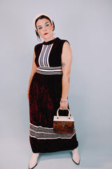 sleeveless floor length maroon velvet dress with mock neck and white striped details