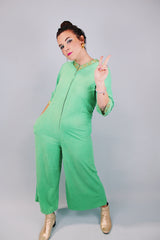 3/4 arm length green velour pajama jumpsuit with gold trim and zipper in front