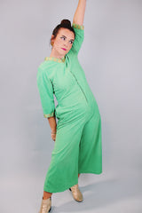 3/4 arm length green velour pajama jumpsuit with gold trim and zipper in front