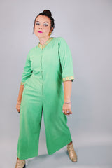 3/4 arm length green velour pajama jumpsuit with gold trim and zipper in front