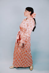 long sleeve peach colored 1950's silky shiny robe with rose print all over