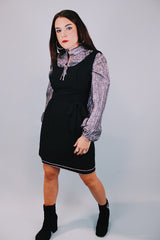 sleeveless scoop neck black mini dress with bow at waist and three tier skirt each with diamond hem 1960's vintage