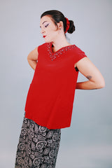sleeveless red velvet blouse with v neck in front and back with embellished trim around neckline and bow in back 1950's vintage