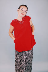 sleeveless red velvet blouse with v neck in front and back with embellished trim around neckline and bow in back 1950's vintage