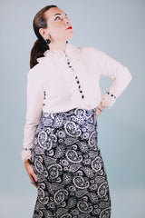 long sleeve white blouse with buttons in the back and chiffon ruffle details around cuffs and neck vintage