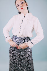 long sleeve white blouse with buttons in the back and chiffon ruffle details around cuffs and neck vintage