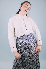long sleeve white blouse with buttons in the back and chiffon ruffle details around cuffs and neck vintage