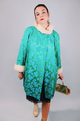 green statin long sleeve knee length jacket with floral pattern and cream faux fur trim around cuffs and neck vintage 1960's