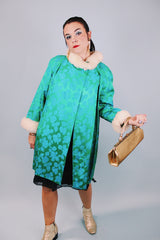 green statin long sleeve knee length jacket with floral pattern and cream faux fur trim around cuffs and neck vintage 1960's
