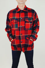 long sleeve vintage men's pendleton wool plaid jacket with collar buttons up the front and pockets in red and dark green plaid print