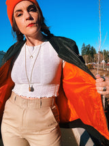 black satin long sleeve bomber jacket with orange interior that is reversible