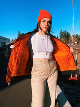 black satin long sleeve bomber jacket with orange interior that is reversible