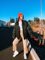 black satin long sleeve bomber jacket with orange interior that is reversible