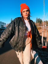 black satin long sleeve bomber jacket with orange interior that is reversible