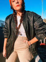 black satin long sleeve bomber jacket with orange interior that is reversible