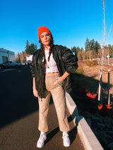 black satin long sleeve bomber jacket with orange interior that is reversible