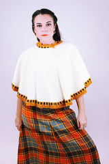 women's 1950's cream wool poncho with orange yarn fringe hem and neck