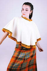 women's 1950's cream wool poncho with orange yarn fringe hem and neck