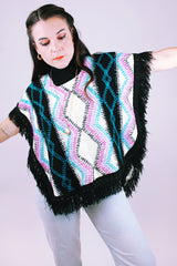 1980's vintage women's acrylic knit poncho with black fringe hem