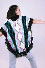 1980's vintage women's acrylic knit poncho with black fringe hem