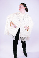 women's 1970's vintage cream acrylic knitted crochet poncho with fringed hem, collar, and buttons
