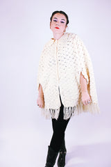 women's 1970's vintage cream acrylic knitted crochet poncho with fringed hem, collar, and buttons