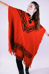 1970's vintage red wool poncho with abstract velvet trim pattern and fringe hem
