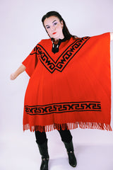 1970's vintage red wool poncho with abstract velvet trim pattern and fringe hem