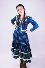 women's vintage 1970's prairie dress in navy blue with ditsy floral print cream crochet trim throughout tie waist and two tiered skirt