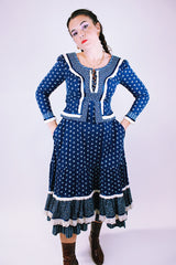 women's vintage 1970's prairie dress in navy blue with ditsy floral print cream crochet trim throughout tie waist and two tiered skirt