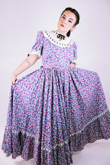 purple floral 1950's prairie dress with large full skirt and black ribbon bows