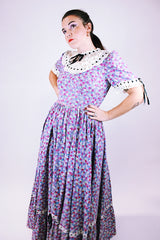 purple floral 1950's prairie dress with large full skirt and black ribbon bows