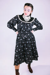 vintage 1970's gunne sax dress with long sleeves in black with ditsy floral print has lace trim and mock neck