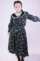 vintage 1970's gunne sax dress with long sleeves in black with ditsy floral print has lace trim and mock neck
