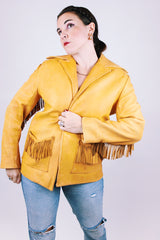 tan women's vintage 1970's genuine leather jacket with fringe, pockets, and double lapel