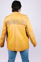 tan women's vintage 1970's genuine leather jacket with fringe, pockets, and double lapel