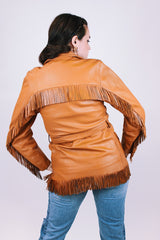 women's vintage leather jacket in camel collar with fringe trim detail, a tie waist, and buttons up the front