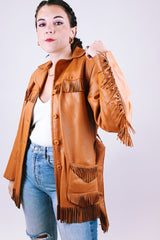 women's vintage leather jacket in camel collar with fringe trim detail, a tie waist, and buttons up the front