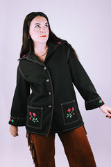 long sleeve women's vintage 1970's button up blouse with collar and pockets in chocolate brown has embroidered flowers