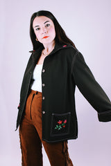 long sleeve women's vintage 1970's button up blouse with collar and pockets in chocolate brown has embroidered flowers