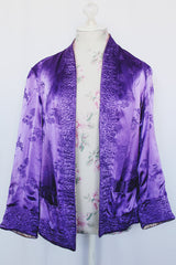 Women's vintage 1950's long sleeve reversible satin open jacket in bright purple and light lavender. Side slits, front pockets and small shoulder pads