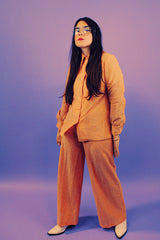 peach metallic set with long sleeve button up collared blouse and elastic waistband pants with slight flair