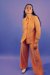 peach metallic set with long sleeve button up collared blouse and elastic waistband pants with slight flair