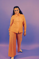 peach metallic set with long sleeve button up collared blouse and elastic waistband pants with slight flair