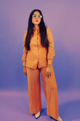 peach metallic set with long sleeve button up collared blouse and elastic waistband pants with slight flair