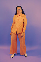 peach metallic set with long sleeve button up collared blouse and elastic waistband pants with slight flair