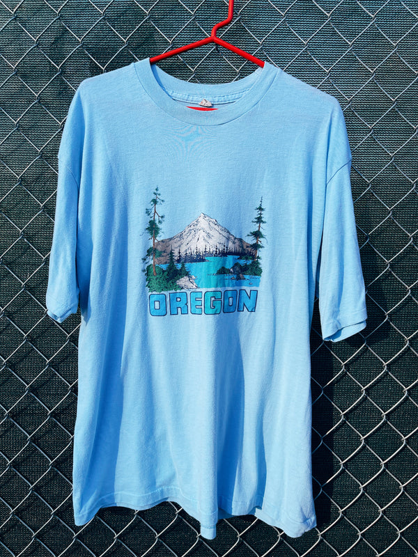Women's or men's vintage 1986's Lexington label short sleeve baby blue graphic t-shirt with Oregon mountain graphic on the front. 