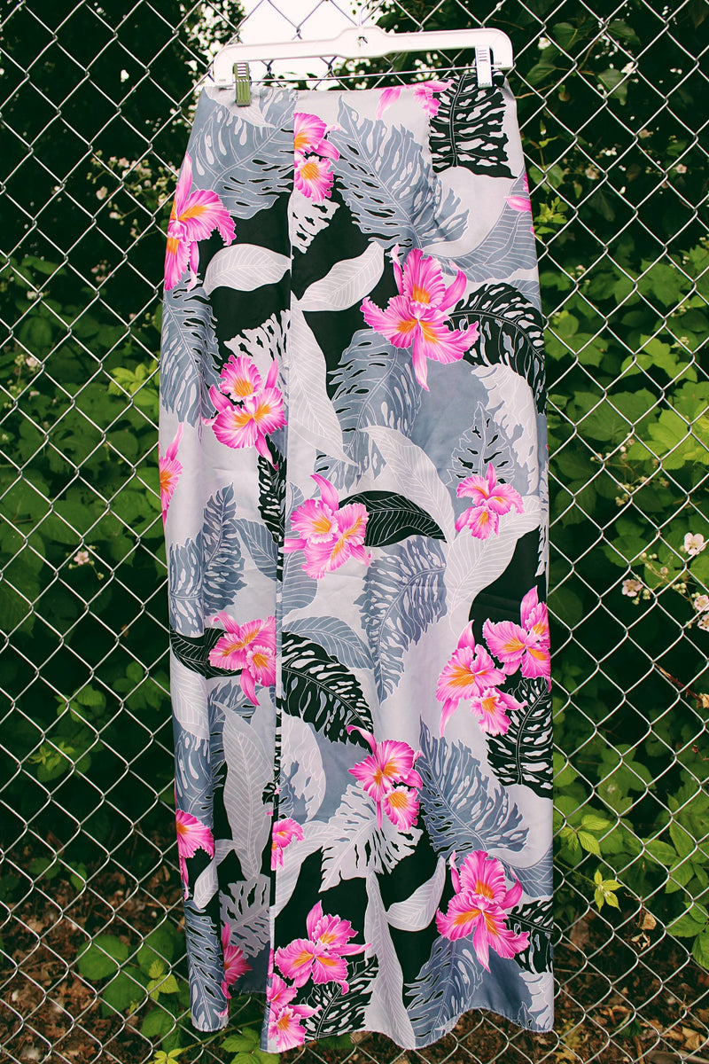 Women's vintage 1980's Helena's, Made in Hawaii label midi length wrap skirt in grey and black with pink Hawaiian floral print. Great as swimsuit cover up.
