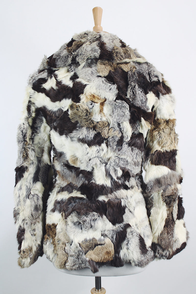 Women's vintage 1970's long sleeve multicolored patchwork genuine fur coat with hook and eye closures in the front. Grey, brown, cream, and black colors