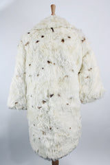 Women's vintage 1960's long sleeve genuine fur pea coat with a double breasted closure. Cream colored with all over brown speckles.